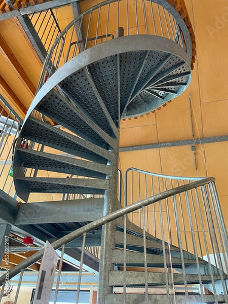 Obraz Open metal spiral staircase seen from bottom to top in bright sunlight, Oostvaardersplassen, Lelystad, Flevoland, Netherlands, June 07, 2025