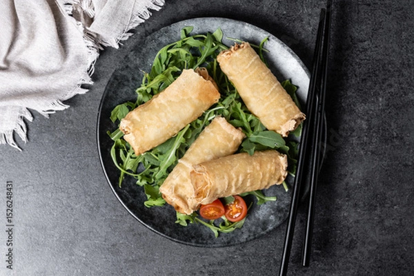 Fototapeta Crispy vegetables spring Rolls on black background. Top view