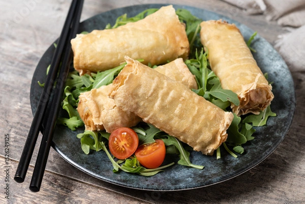 Fototapeta Crispy vegetables spring Rolls on wooden table