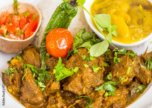 Obraz Cabri massalé, riz, gros pois et rougail tomates