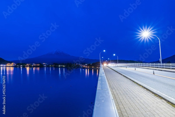 Fototapeta Enjoying the nighttime lake view of Mount Fuji from the Kawaguchiko Ohashi Bridge.Japan.
