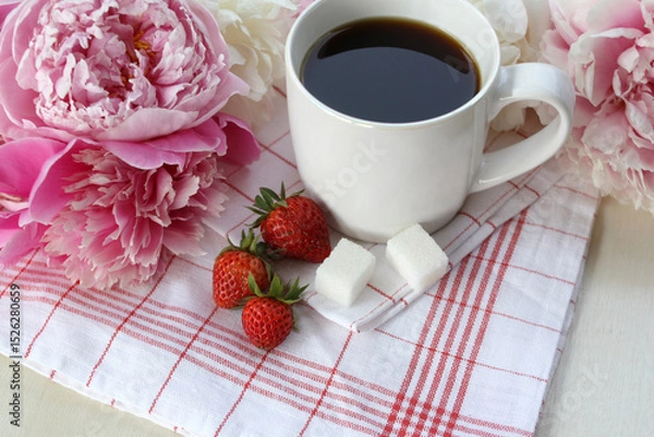 Obraz A cup of coffee and peonies flowers on the table. Cozy morning coffee with peonies for relaxation.