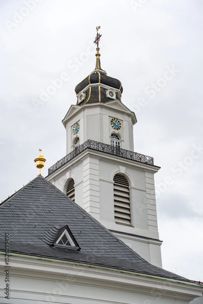 Obraz A tall white Friedenskirche church tower with a clock on the front in Saarbrucken Germany