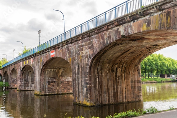 Obraz A old bridge with a red and white sign on it in Saarbrucken Germany