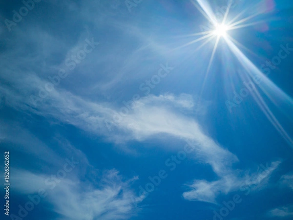 Obraz A beautiful sky with white clouds and rays of sunshine.