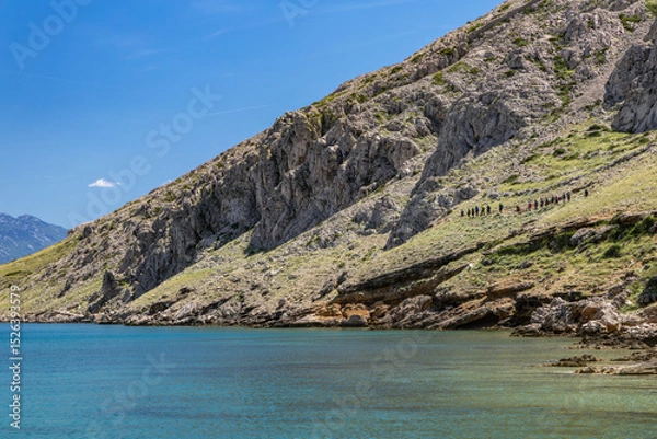 Fototapeta Panorama of the bay with the Vela Luka beach below, view of the beach from the top of the mountain, rocky beach