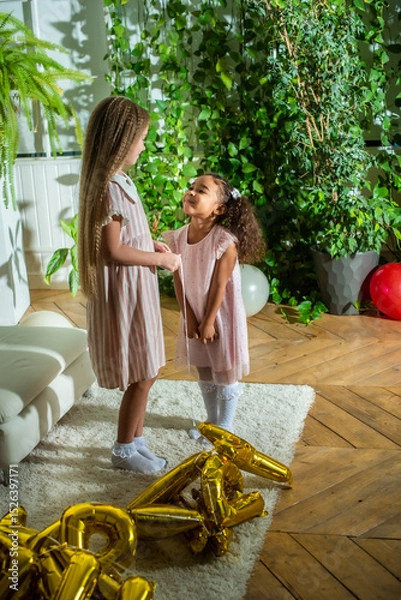 Obraz girls, Sisters joyfully embracing each other in a lush and cozy living space filled with warmth
