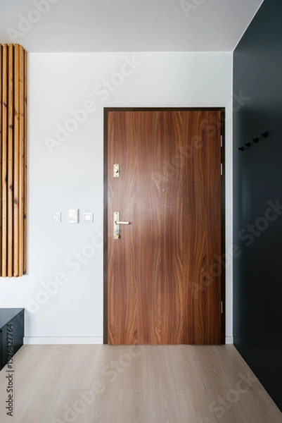 Obraz Modern wooden front door leading into an elegant residential hallway space