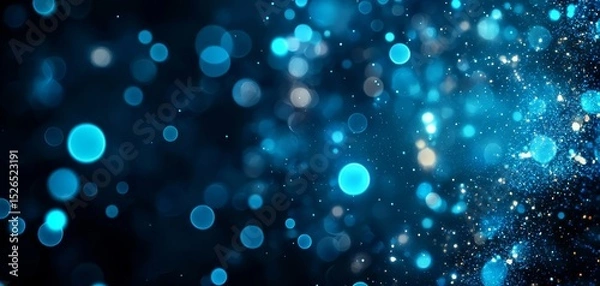 Fototapeta A vibrant, abstract background featuring blue bokeh lights and shimmering particles, creating a sense of depth and ethereal beauty.