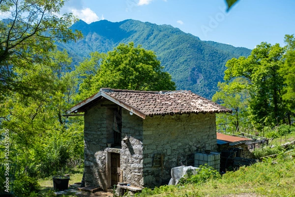 Obraz charming stone house in tranquil Italian mountain setting, ancient traditional heritage, Mysterious Mountain Retreat, Alpine Architecture European mountain villages