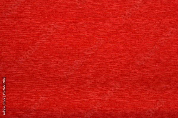 Obraz A detailed close-up shot captures the textured surface of a vibrant red crepe paper, showing its distinct parallel wrinkles