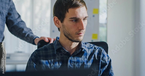 Fototapeta Team adult male engineer collaborate on robotic hand project using AI code solutions machine learning at tech workspace. Artificial intelligence interface, collaboration support prototype development.