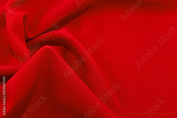 Fototapeta The background of the banner for the site from a piece of fabric. Texture of silk or satin fabric in red color. Textile
