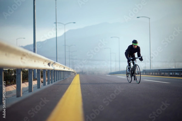 Fototapeta Bicycle rider on the high way