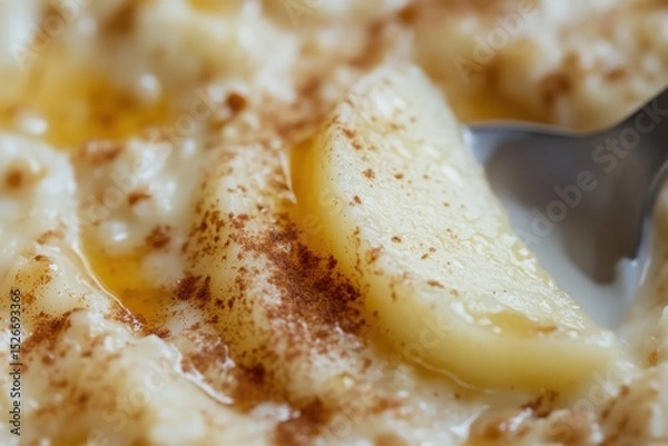 Fototapeta Close-up of creamy oatmeal with banana and cinnamon drizzle  