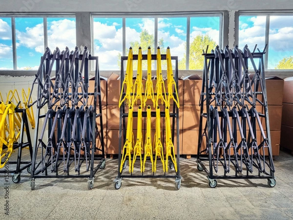 Fototapeta Production line of painted bicycle frames arranged on a rack in a factory