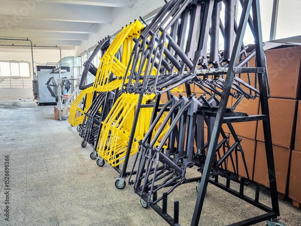 Fototapeta Production line of painted bicycle frames arranged on a rack in a factory