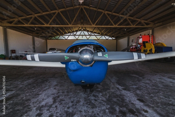 Fototapeta An airplane parked in a hanger. It's a aircraft on an airport