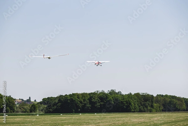 Fototapeta An airplane in fligt over a airfield. An aircraft for transportation in aviation