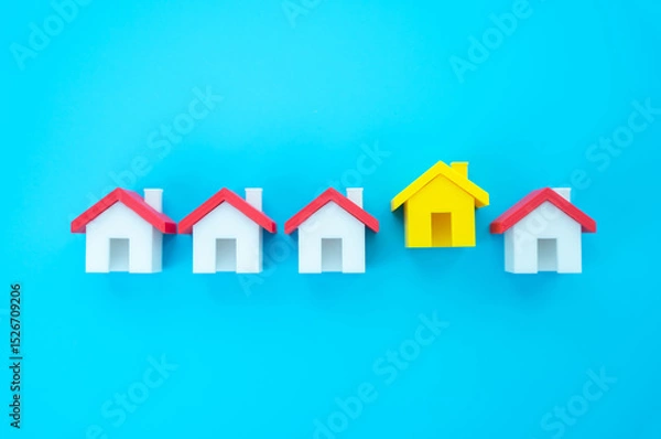 Fototapeta The yellow house stands out from the row. Choosing the best home to buy or rent. Highlights real estate selection, attractive rental or purchase options, and the search for ideal living conditions.