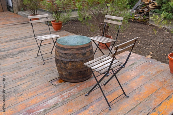 Fototapeta Wooden Barrel Table Chairs at Decking in Garden