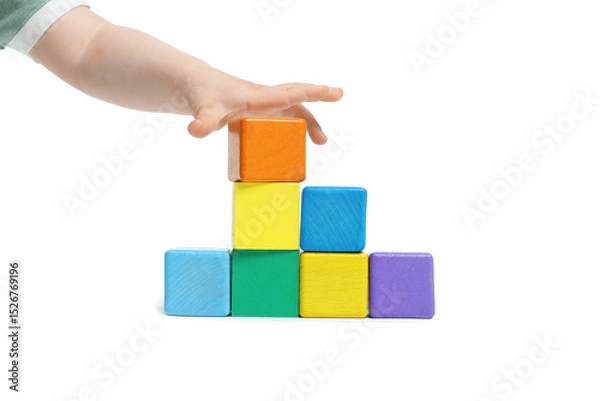 Fototapeta Child playing with colorful cubes on white background, closeup