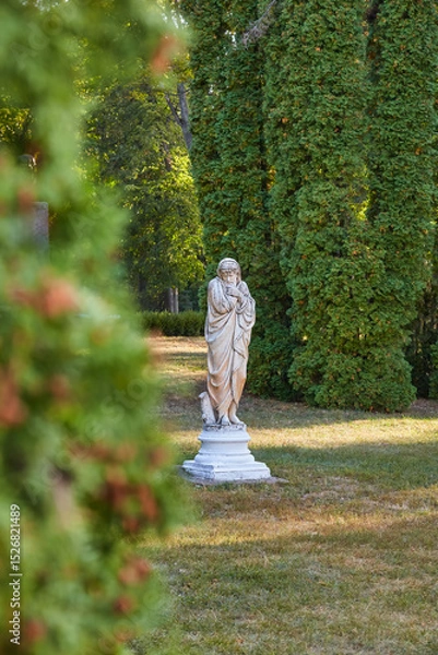 Fototapeta Aged Stone Statue in Secluded Park Nook