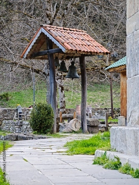 Fototapeta Bells hanging in a small belfry with tiled roof in Nekresi Monastery