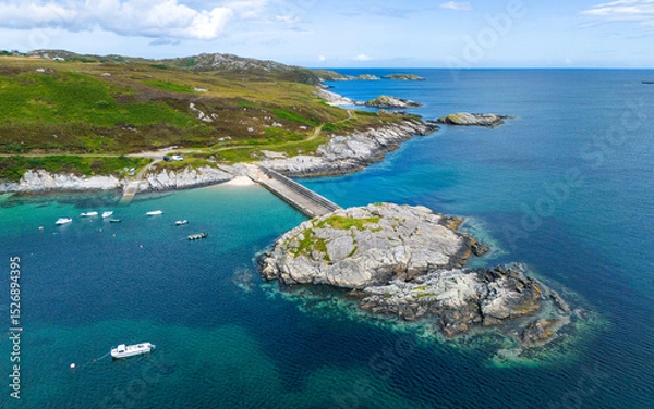 Fototapeta Aerial view of rocky island connected to the mainland by a stone quay in Talmine harbor, Scotland