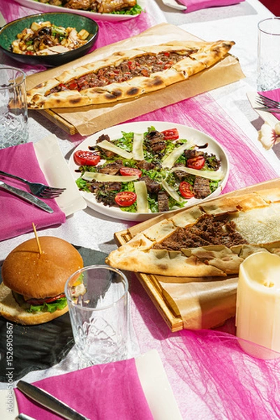 Fototapeta Close-Up of Burger, Salad, and Flatbread on Event Table