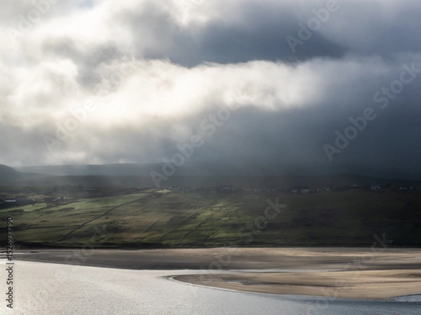 Fototapeta Mist-covered hills in the Scottish highlands with beach and dramatic clouds, Sutherland, Scotland