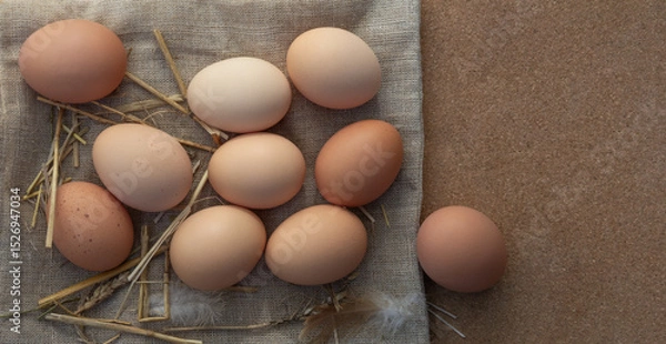 Obraz Farm eggs on burlap and straw with space for text. Rustic flat lay, top view