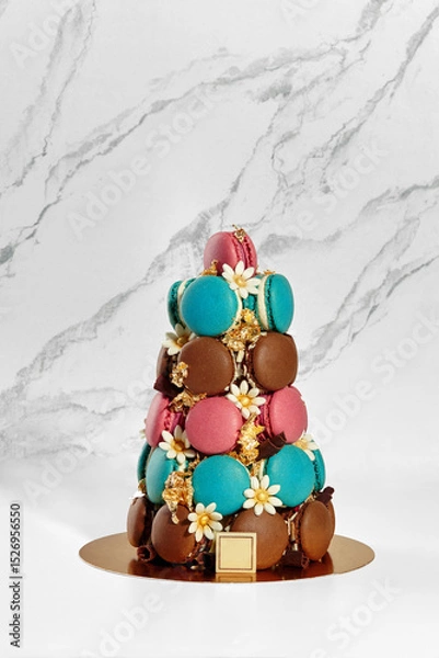 Fototapeta Colorful macarons forming a pyramid on marble background