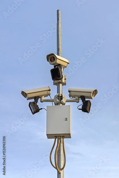 Fototapeta Three CCTV Security Cameras at Pole Surveillance System for Town Centre