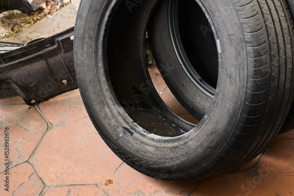 Fototapeta Tire with stagnant water, potential source of dengue or malaria mosquitoes
