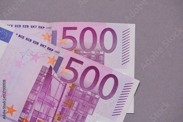 Fototapeta Close-up view of banknotes showing intricate details of 500 euro currency, emphasizing design elements and color patterns