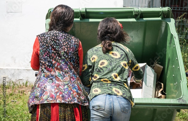 Obraz poor people searching in a dumpster