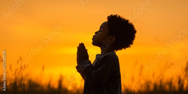 Obraz Silhouette of a Child Praying at Sunset with Hands Clasped