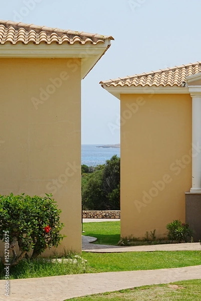 Obraz Ocean view through a gap between two houses