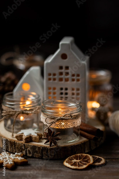 Obraz Creative handmade christmas home decor decorations: simple glass jars with aroma candles decorated with a ribbon, cinnamon, anise, dry orange. Cozy atmospheric composition for holiday mood creation