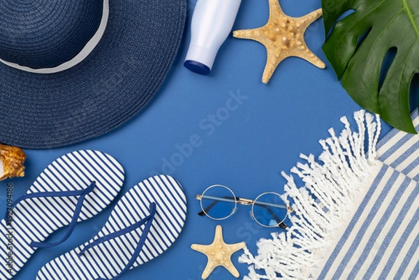 Fototapeta Blue beach accessories on color background, top view. Copy space for text