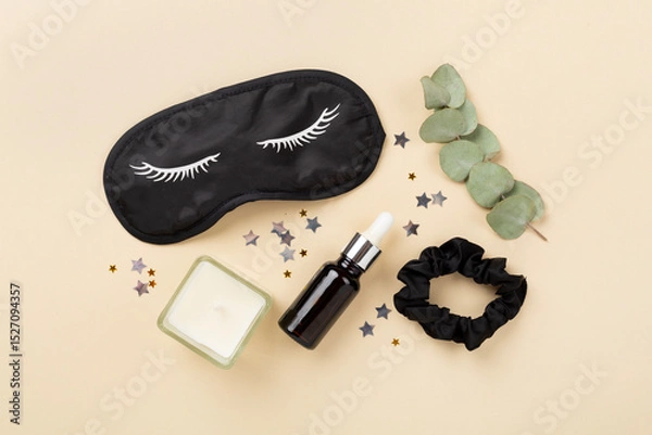 Fototapeta Sleeping mask with accessories on color background, top view. Sleeping routine concept