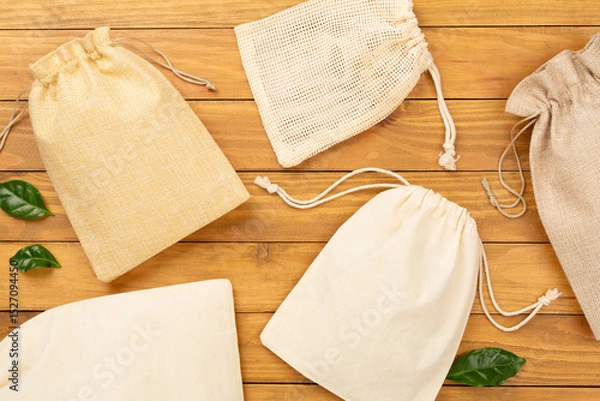 Fototapeta Small eco sack on wooden background, top view