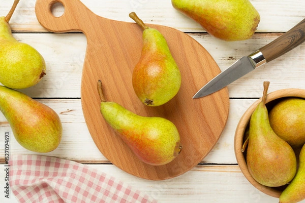 Fototapeta Fresh red and green pears on wooden background,top view