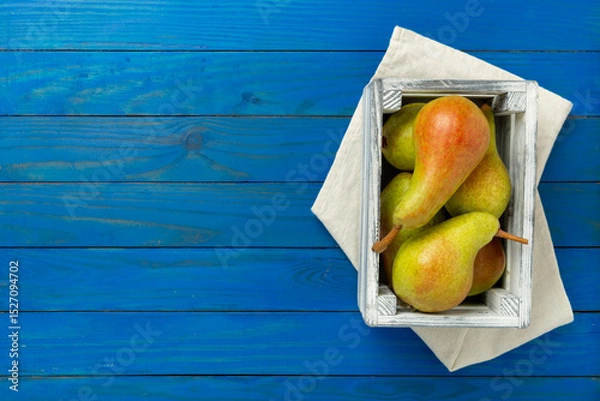 Fototapeta Fresh red and green pears on wooden background,top view