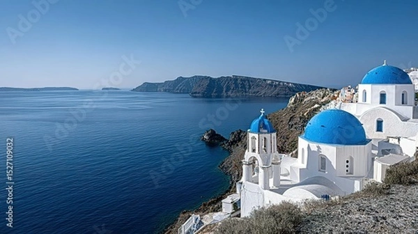 Obraz Whitewashed churches with blue domes overlooking a tranquil sea.