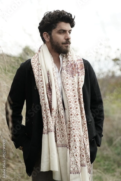 Fototapeta A Kashmiri model dressed in a traditional shawl and vintage-style pheran, posing for a Kaar Kash shoot that highlights timeless craftsmanship and the cultural soul of Kashmir.

