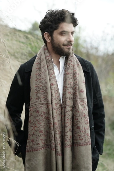 Fototapeta A Kashmiri model dressed in a traditional shawl and vintage-style pheran, posing for a Kaar Kash shoot that highlights timeless craftsmanship and the cultural soul of Kashmir.

