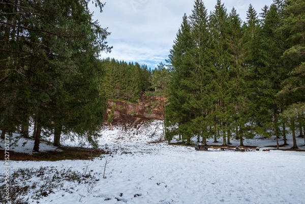 Obraz Vedema ski slope covered in snow with a dense pine forest and visible rock face in Hässleholm, Sweden