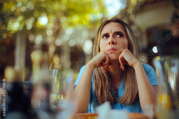 Fototapeta Woman Overthinking her Problems Sitting in a restaurant. Frustrated person feeling overwhelmed with negative thoughts 

